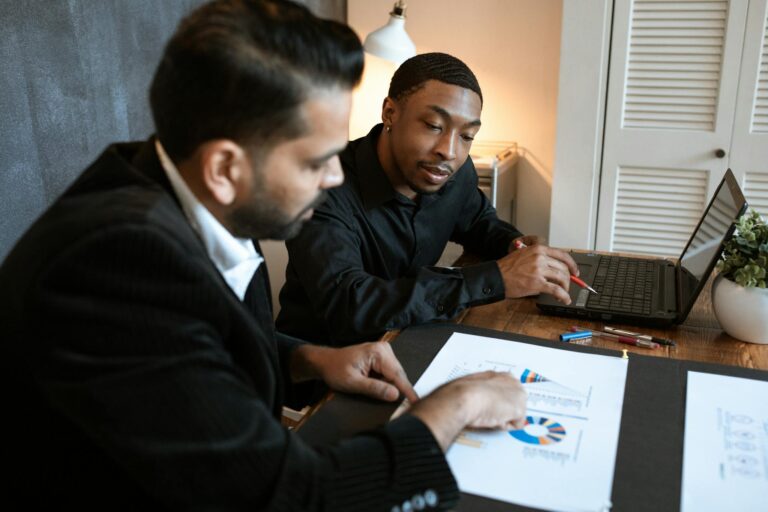 Photo by RDNE Stock project - BizRanger Hub Two professionals discussing charts and graphs in a contemporary office.