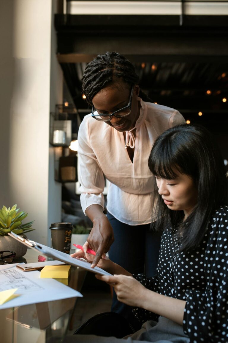 Photo by RDNE Stock project - BizRanger Hub Two women collaborate in a modern office space, focused on creativity and teamwork.